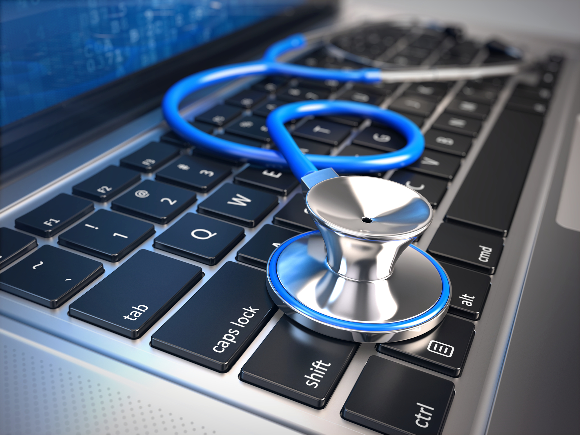 A stethoscope lies on a laptop keyboard, symbolizing it services for healthcare or digital healthcare.