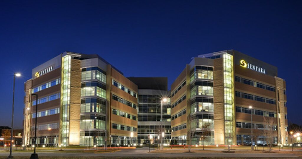 A digitally secured office building with efficient IT support and network management illuminated at night.