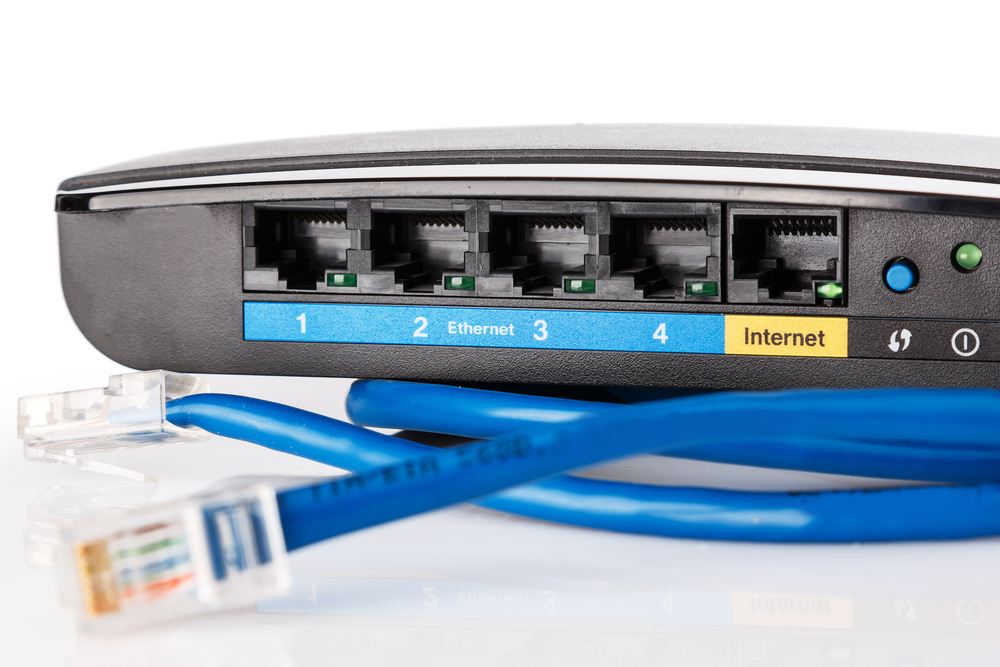 A blue ethernet cable is connected to a router for IT Support.