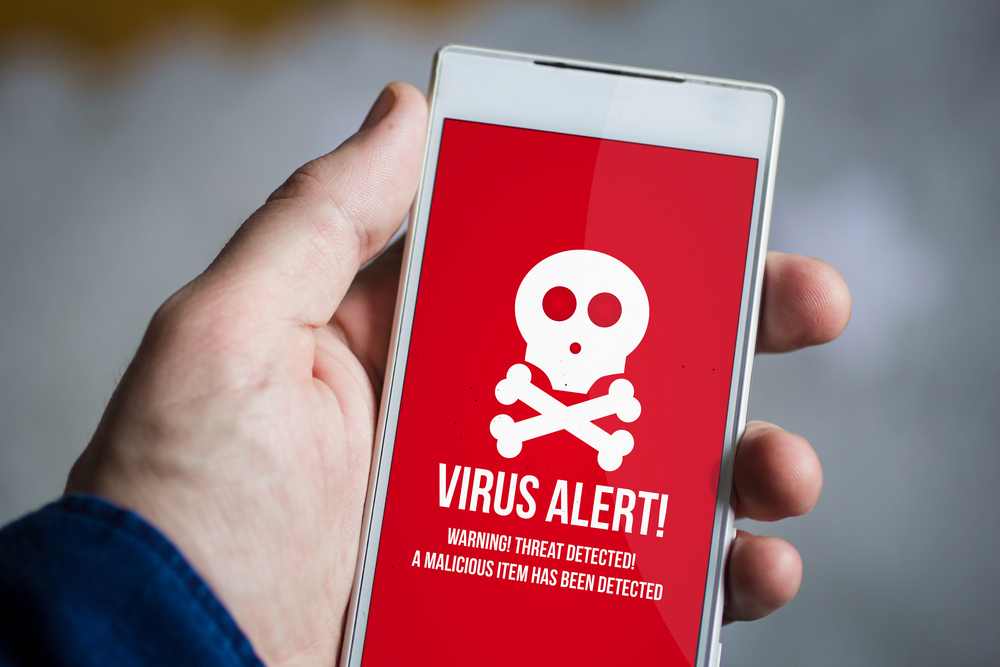 Guarding against the New Wave of Android Malware with a smartphone displaying a virus alert.