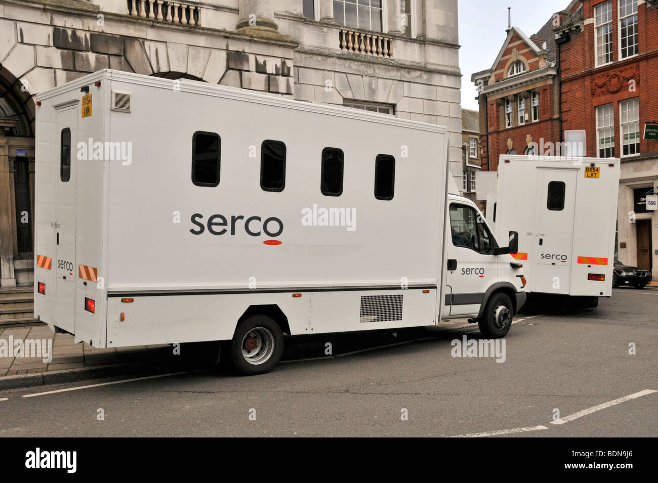 Two serco vans parked in front of a building in london, england - stock image.