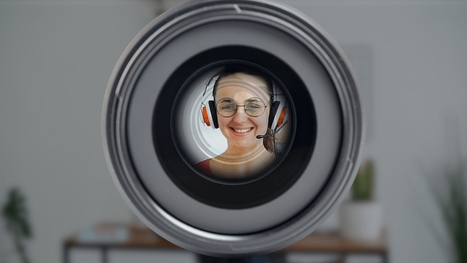 An image of a woman with headphones in front of a camera to Improve video call quality