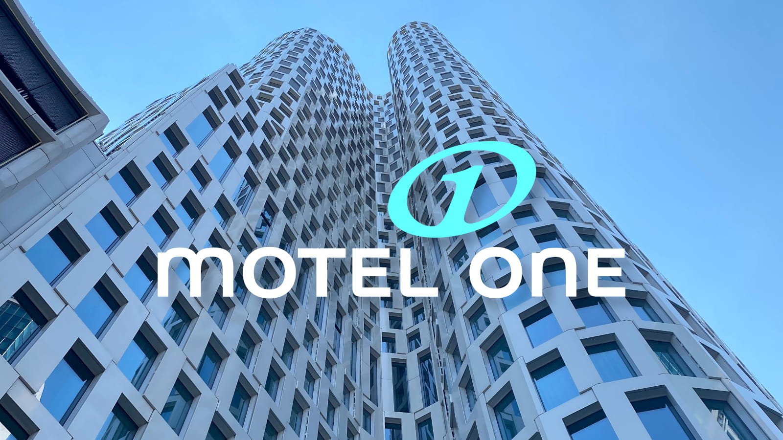 Motel One logo in front of a tall building amidst devastating ransomware assault.