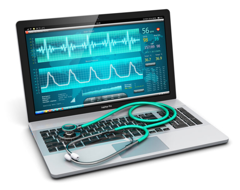 A laptop displaying healthcare industry monitoring software with graphs and vital signs, alongside a green stethoscope resting on its keyboard.